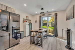 Dining space featuring light wood finished floors and recessed lighting