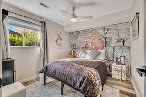 Bedroom with wood finished floors and a ceiling fan