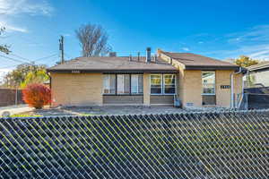 Rear view of property featuring brick siding