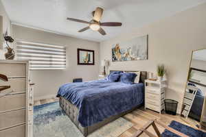 Bedroom featuring light wood-type flooring and a ceiling fan