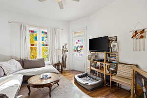 Living room with wood finished floors and a ceiling fan