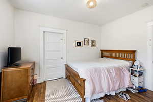 Bedroom featuring dark wood-type flooring