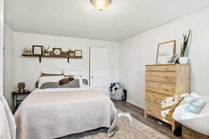Bedroom featuring wood finished floors and baseboards