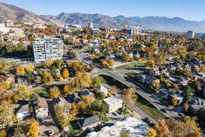 Aerial overview of property's location featuring mountains and nearby suburban area