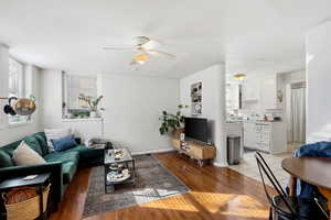 Living area featuring light wood finished floors and a ceiling fan