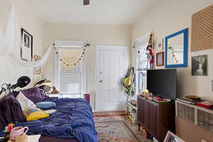 Bedroom featuring wood finished floors and a ceiling fan