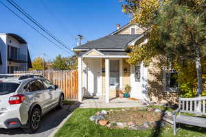 View of front of house featuring roof with shingles and a porch