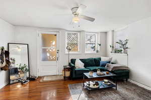 Living room with ceiling fan and wood finished floors