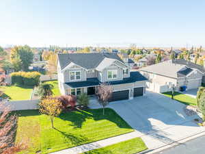 Craftsman inspired home with a residential/mountain view, concrete driveway, board and batten siding, and a porch