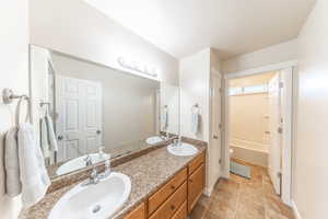 Full bathroom with double vanity and  shower combination