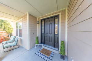 View of exterior entry featuring a porch