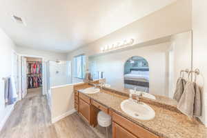 Ensuite master bathroom with spacious closet, double vanity, separate tub and large shower