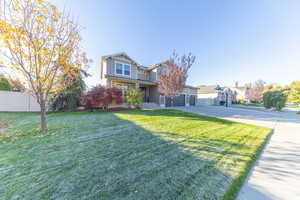 View of front of property featuring concrete driveway, board and batten siding, a garage, and covered porch