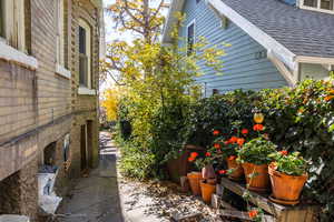 View of side of property with a shingled roof