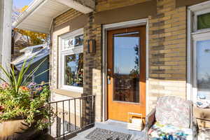 Doorway to property with brick siding