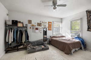 Bedroom featuring ceiling fan and hardwood / wood-style floors