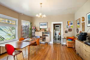 Dining area with light wood-style flooring and a chandelier