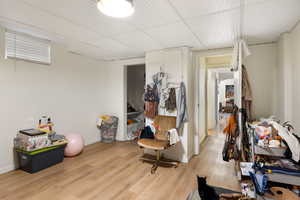 Miscellaneous room featuring light wood-type flooring and baseboards