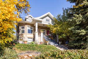 View of front of home featuring stairway and a porch