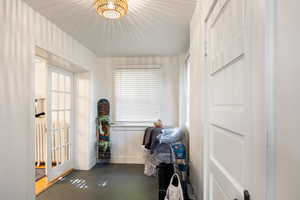 Laundry area featuring finished concrete floors and baseboards
