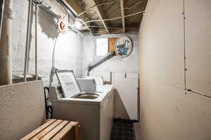 Shared laundry room with separate washer and dryer