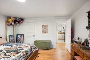 Bedroom featuring light wood-style floors and a closet