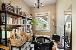 Misc room featuring radiator heating unit and a chandelier