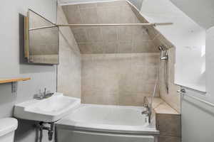 Full bathroom with shower / tub combination and vaulted ceiling