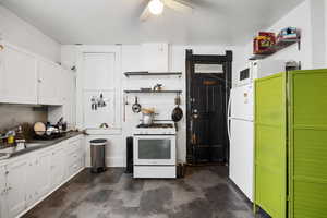 Kitchen with white appliances, open shelves, a ceiling fan, and white cabinetry