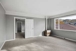 Empty room with carpet floors and baseboards
