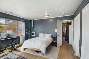 Bedroom featuring light wood-type flooring and heating unit