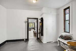 Corridor with baseboards and wood finished floors