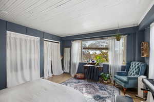 Bedroom featuring wood finished floors and two closets
