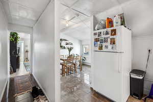 Kitchen featuring freestanding refrigerator and baseboards