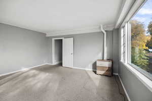 Empty room featuring carpet floors and baseboards