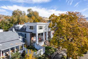 Back of house with a mountain view and view of scattered trees