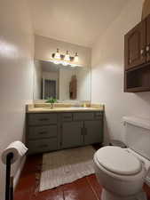 Bathroom featuring vanity and dark tile patterned flooring