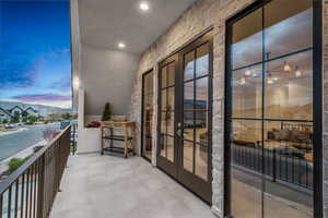 Balcony of of family door at dusk featuring French doors