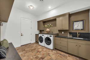 Laundry area featuring cabinet space, washing machine and clothes dryer, stone finish floors, and recessed lighting