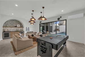 Rec room opens to the pool with kitchenette