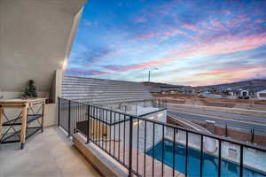 Balcony off bedroom with view of pool