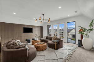 Carpeted living room with suspended lighting