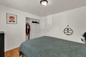 Bedroom with a closet and wood finished floors
