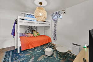 Bedroom featuring baseboards and tile patterned floors
