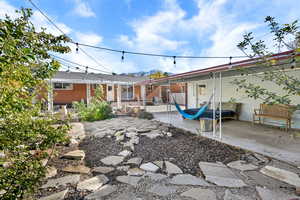 Rear view of property featuring a patio area, brick siding, and a mountain view