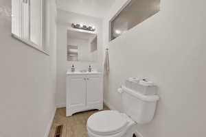Half bath with vanity and light tile patterned floors