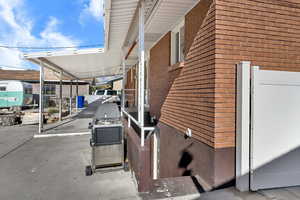 View of property exterior with brick siding