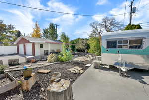 View of patio / terrace featuring an outbuilding and a vegetable garden