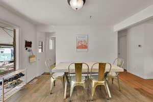 Dining space featuring a textured ceiling and light wood-style floors