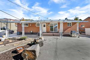 Back of house with a patio area and brick siding